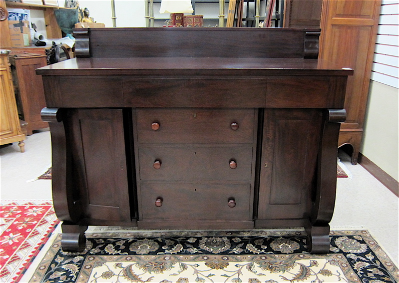 Appraisal: EMPIRE REVIVAL MAHOGANY SIDEBOARD American c having three aligned drawers