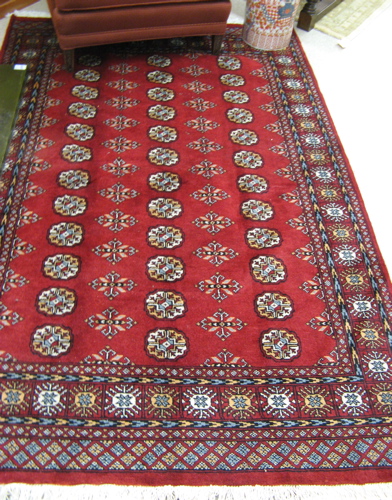 Appraisal: RED BOKHARA CARPET with columns of repeating Turkoman gols in