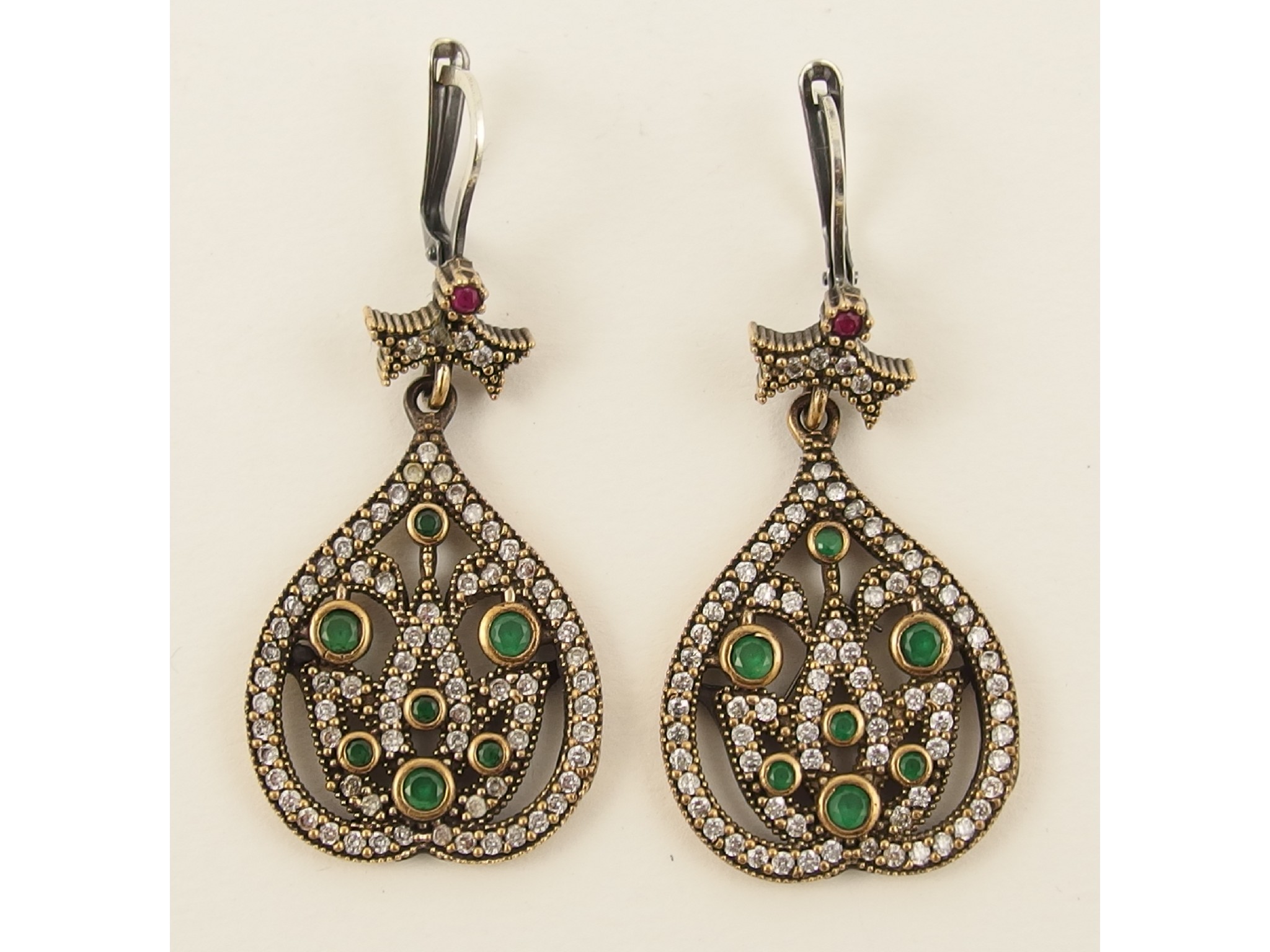 Appraisal: A pair of bronze and silver earrings set with green