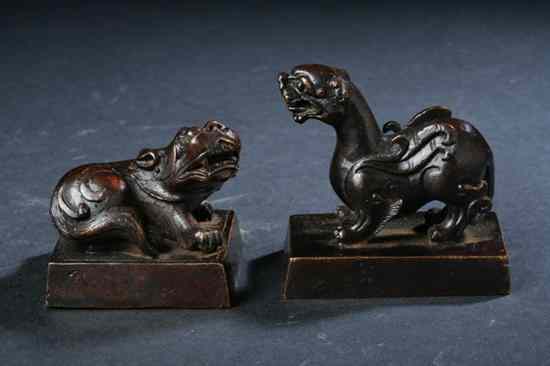 Appraisal: TWO CHINESE BRONZE SEALS Each with mythical beast finial -