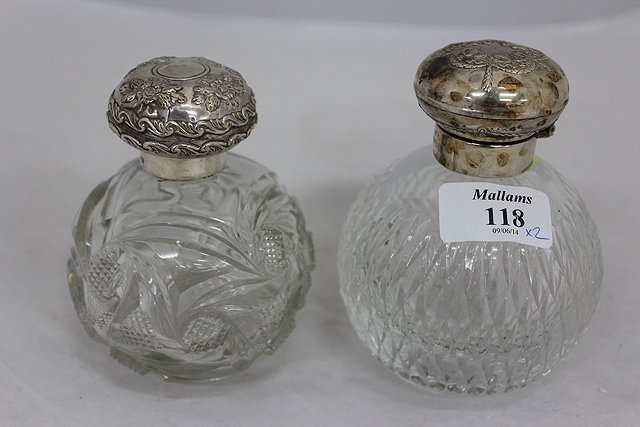 Appraisal: TWO GLOBULAR CUT GLASS SCENT BOTTLES with silver lids the