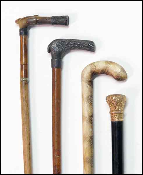 Appraisal: FOUR WALKING STICKS Comprised of one entirely covered in snakeskin