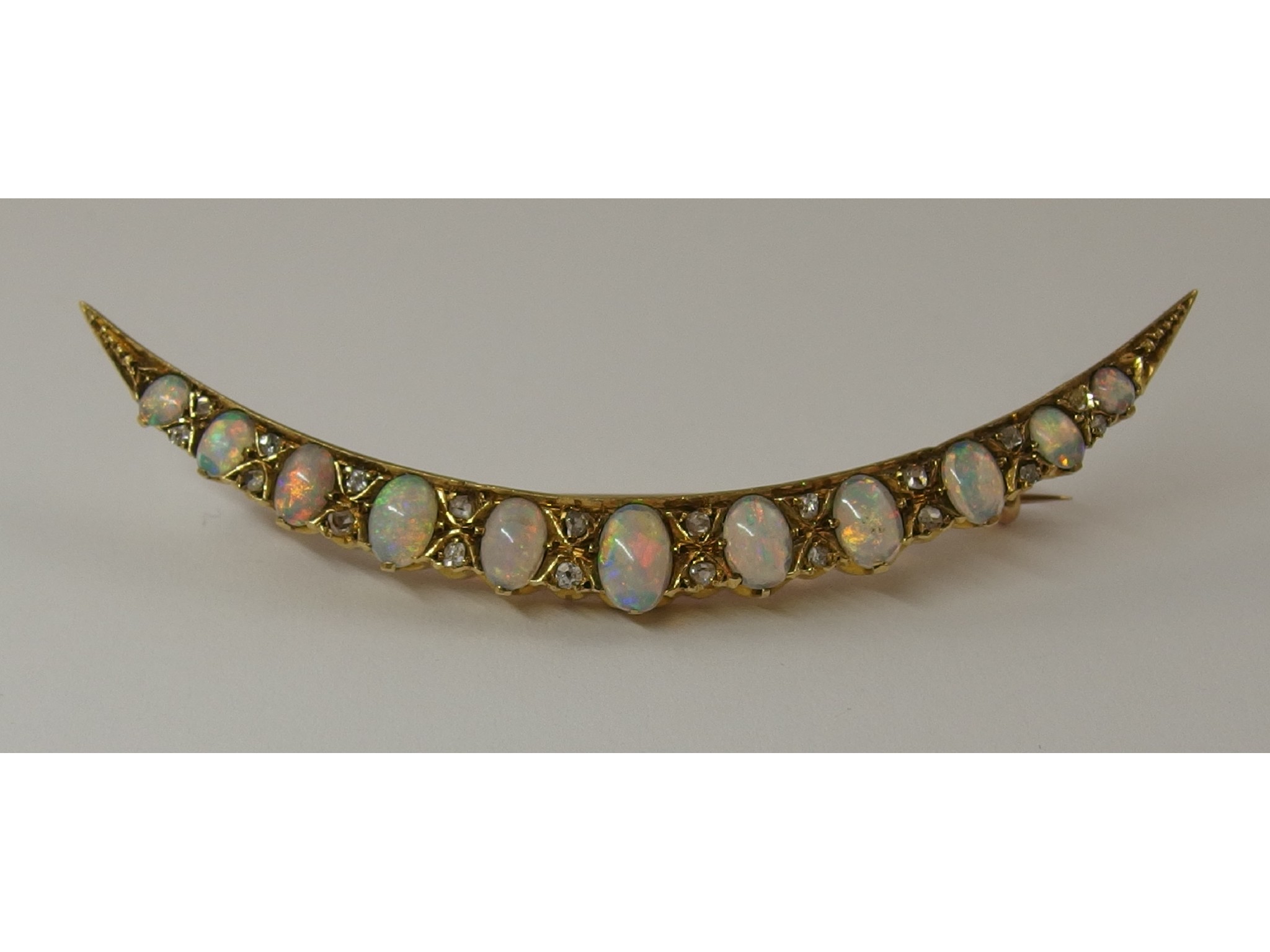 Appraisal: An opal and diamond crescent moon broochthe eleven oval white