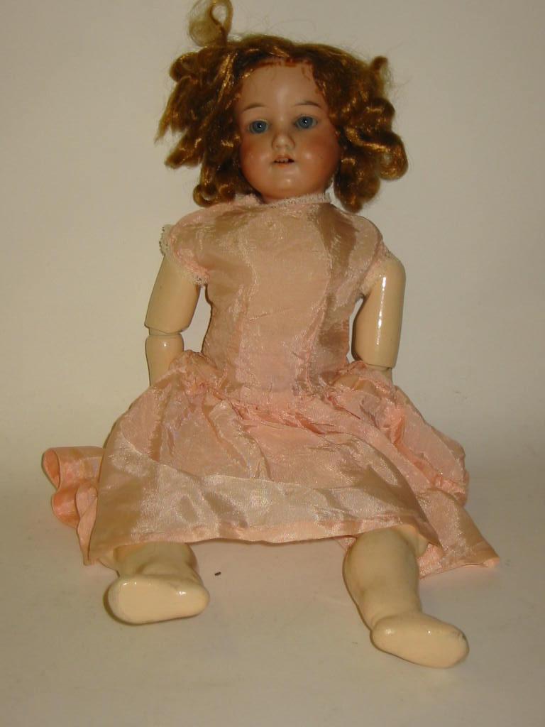 Appraisal: An Armand Marseille bisque head girl doll with blue glass