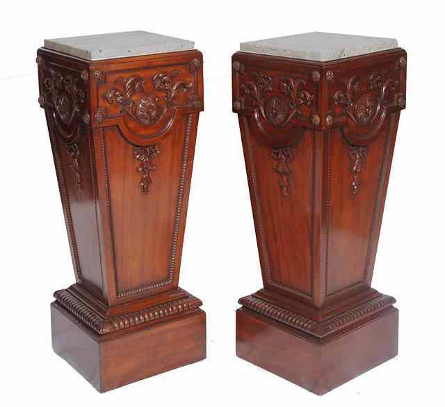 Appraisal: A PAIR OF MAHOGANY SQUARE TAPERING PEDESTALS with carved rosette