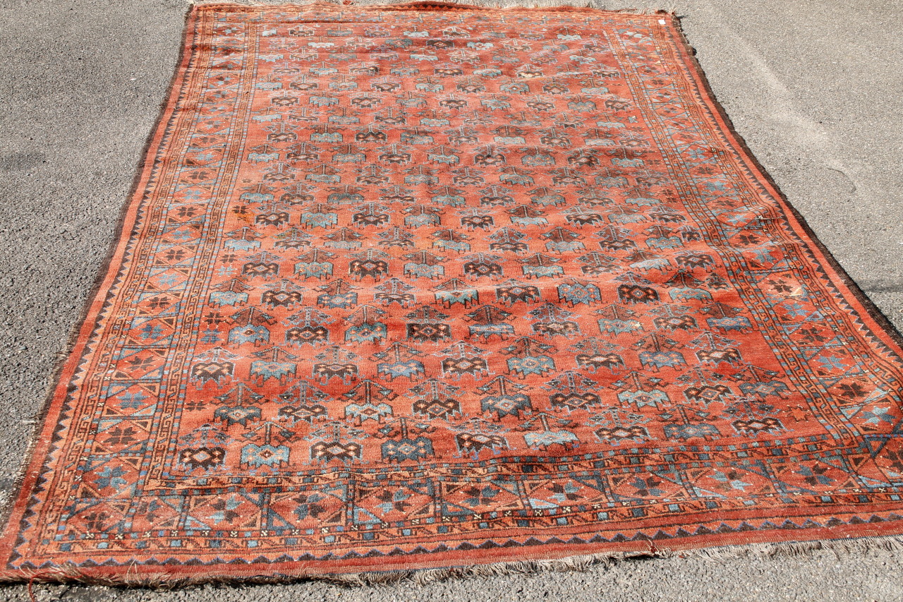 Appraisal: An early thC Persian style rug in geometric pattern predominantly