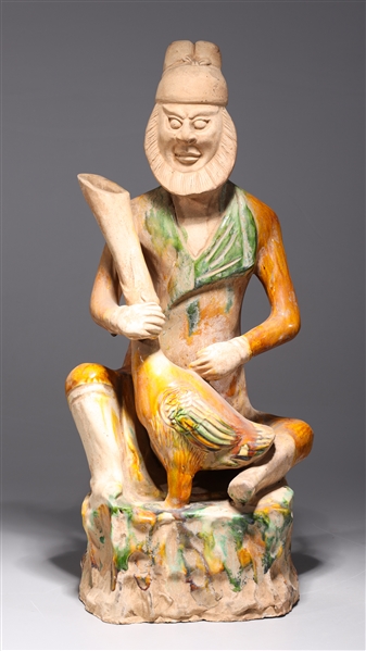 Appraisal: Chinese sancai glazed ceramic statue of a man holding an