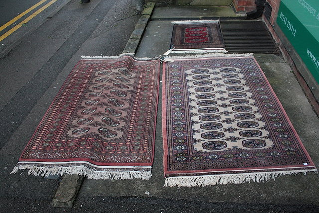 Appraisal: A COLLECTION OF THREE PAKISTAN BOKHARA TYPE RUGS largest cm