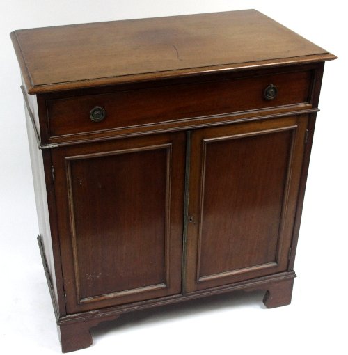 Appraisal: An Edwardian mahogany cabinet fitted a drawer above cupboard doors