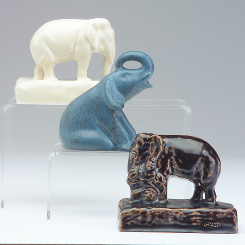 Appraisal: ROOKWOOD Three Production elephant paperweights in blue glossy dark brown