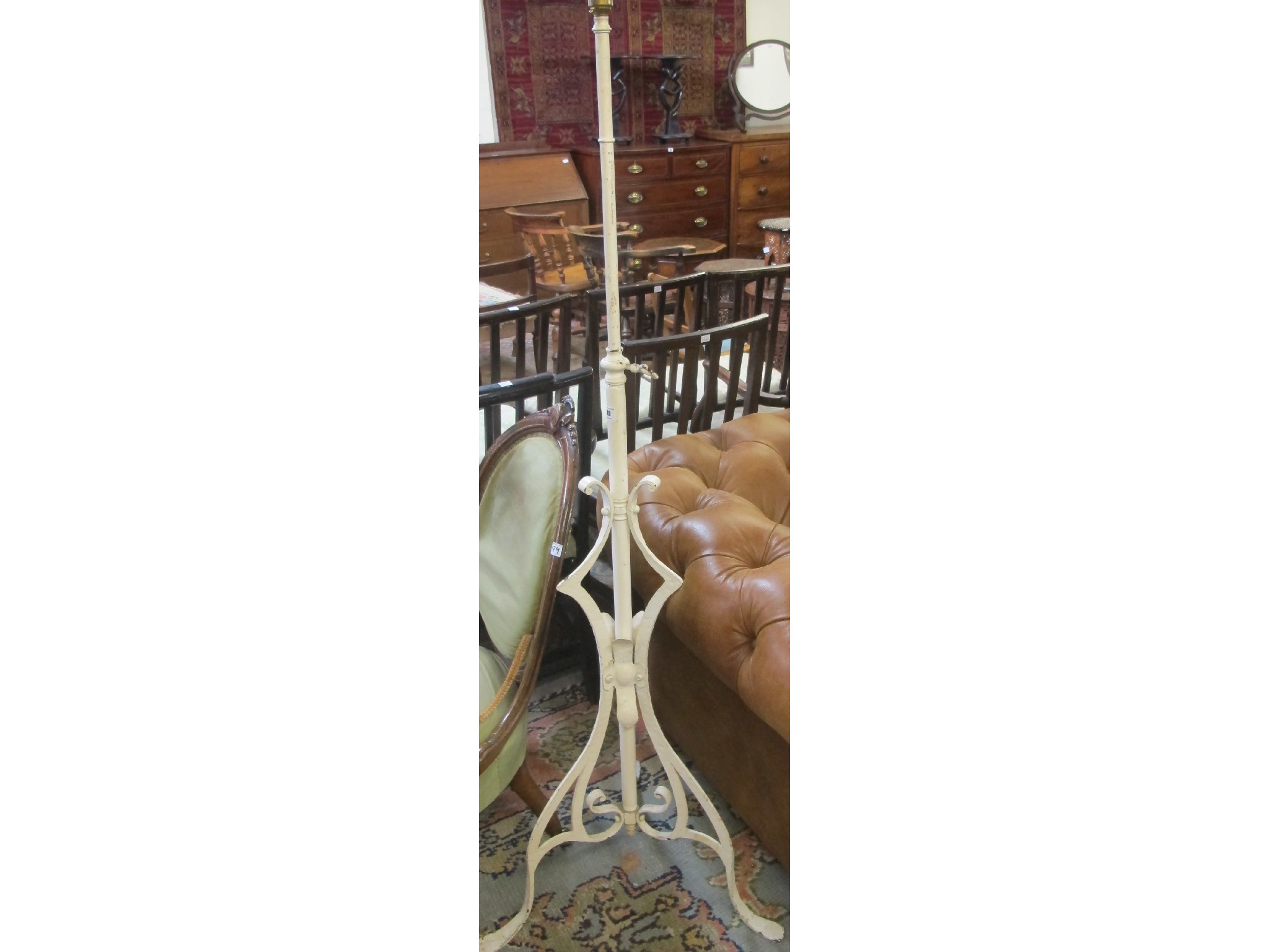 Appraisal: A wrought iron standard lamp with tripod base