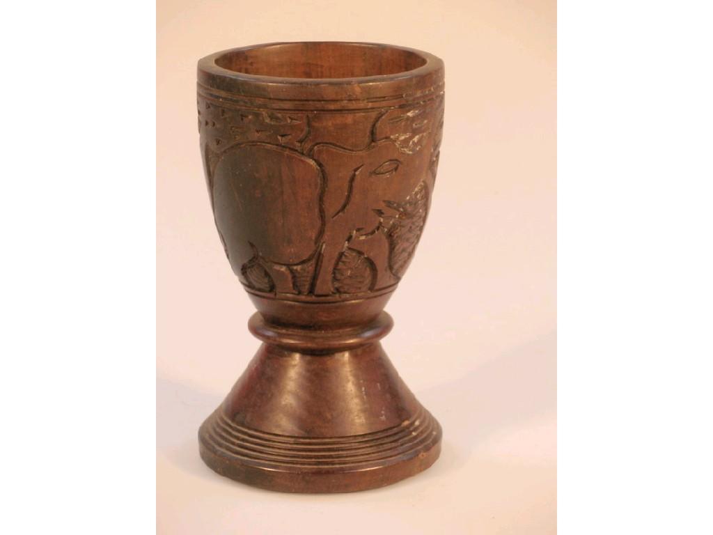 Appraisal: An African treen drinking vessel carved in relief with rhinoceros