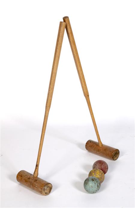 Appraisal: An Edwardian part croquet set comprising four mallets eight balls