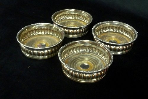 Appraisal: A set of four Sheffield plated wine coasters each of