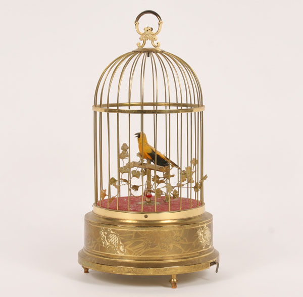 Appraisal: German singing bird automoton brass cage with painted accents bird