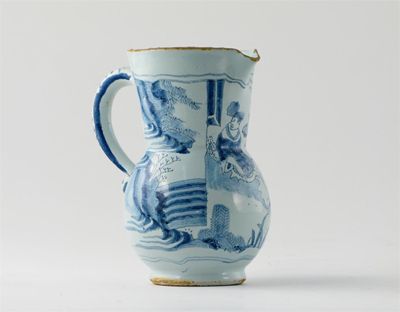 Appraisal: A Delftware jug painted in blue with an Oriental figure