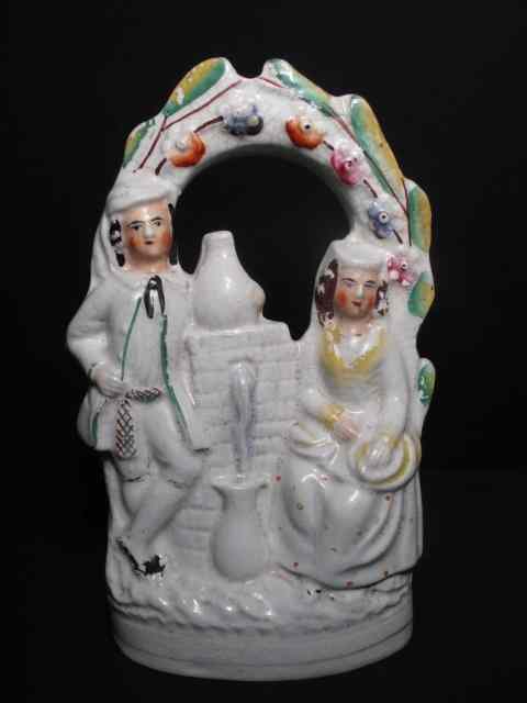 Appraisal: th century English Staffordshire figurine depicting two sweethearts under an