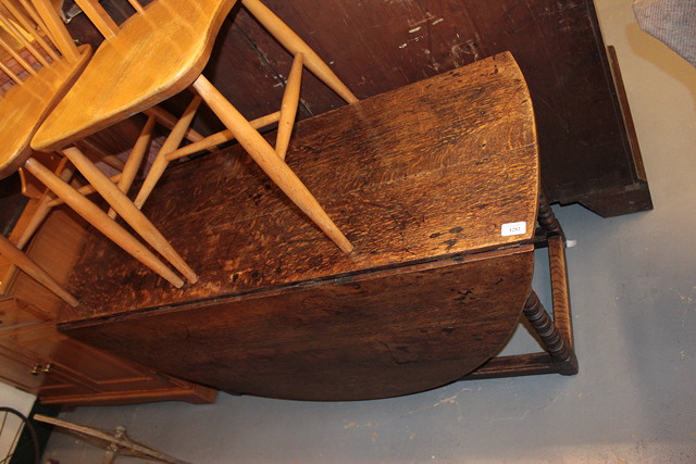 Appraisal: AN ANTIQUE OAK OVAL GATELEG TABLE with bobbin and reel