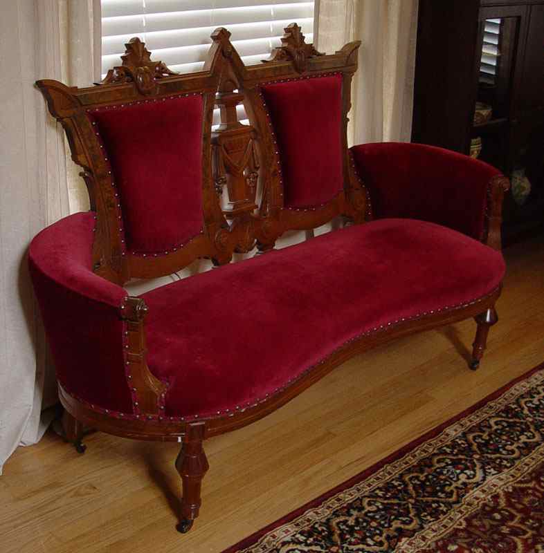 Appraisal: CARVED VICTORIAN SETTEE Carved and shaped back and arms with