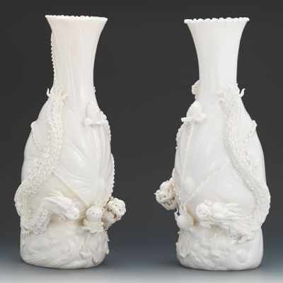 Appraisal: A Pair of Blanc de Chine Dragon Vases Beautiful modeled