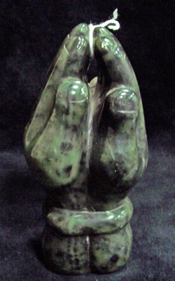 Appraisal: John Takawi a carved variegated marble figure with hands clasped