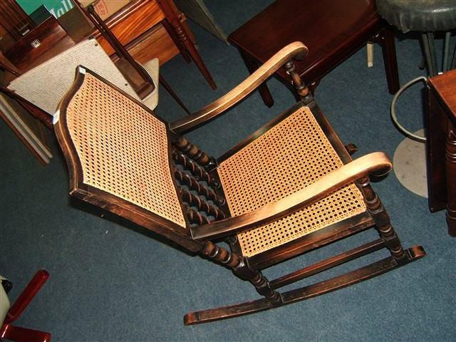 Appraisal: An early th Century beechwood rocking chair with caned back