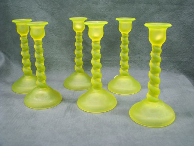 Appraisal: Six vaseline glass candlesticks with twist-motif stems inches tall