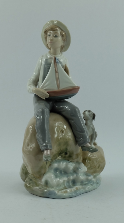 Appraisal: Lladro figure of boy dog seated on rock by the