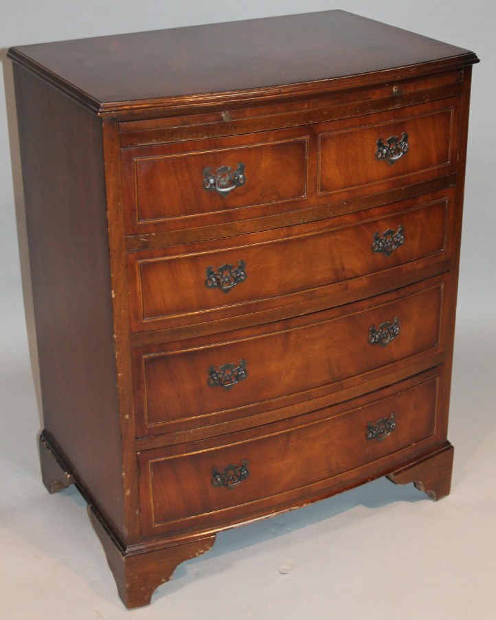 Appraisal: A mid- thC walnut veneered bachelors chest the moulded overhanging