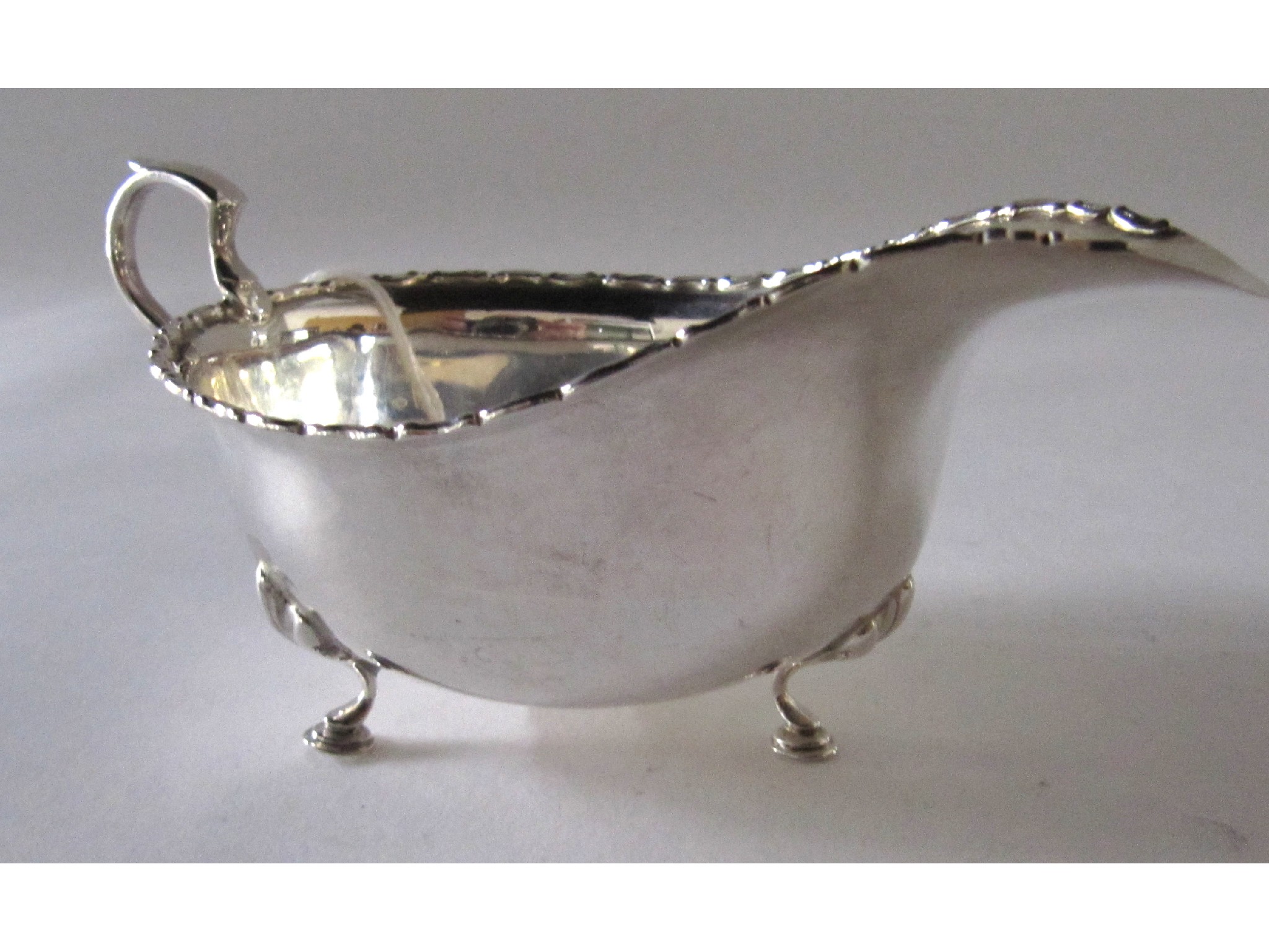 Appraisal: A silver sauceboat rubbed marks