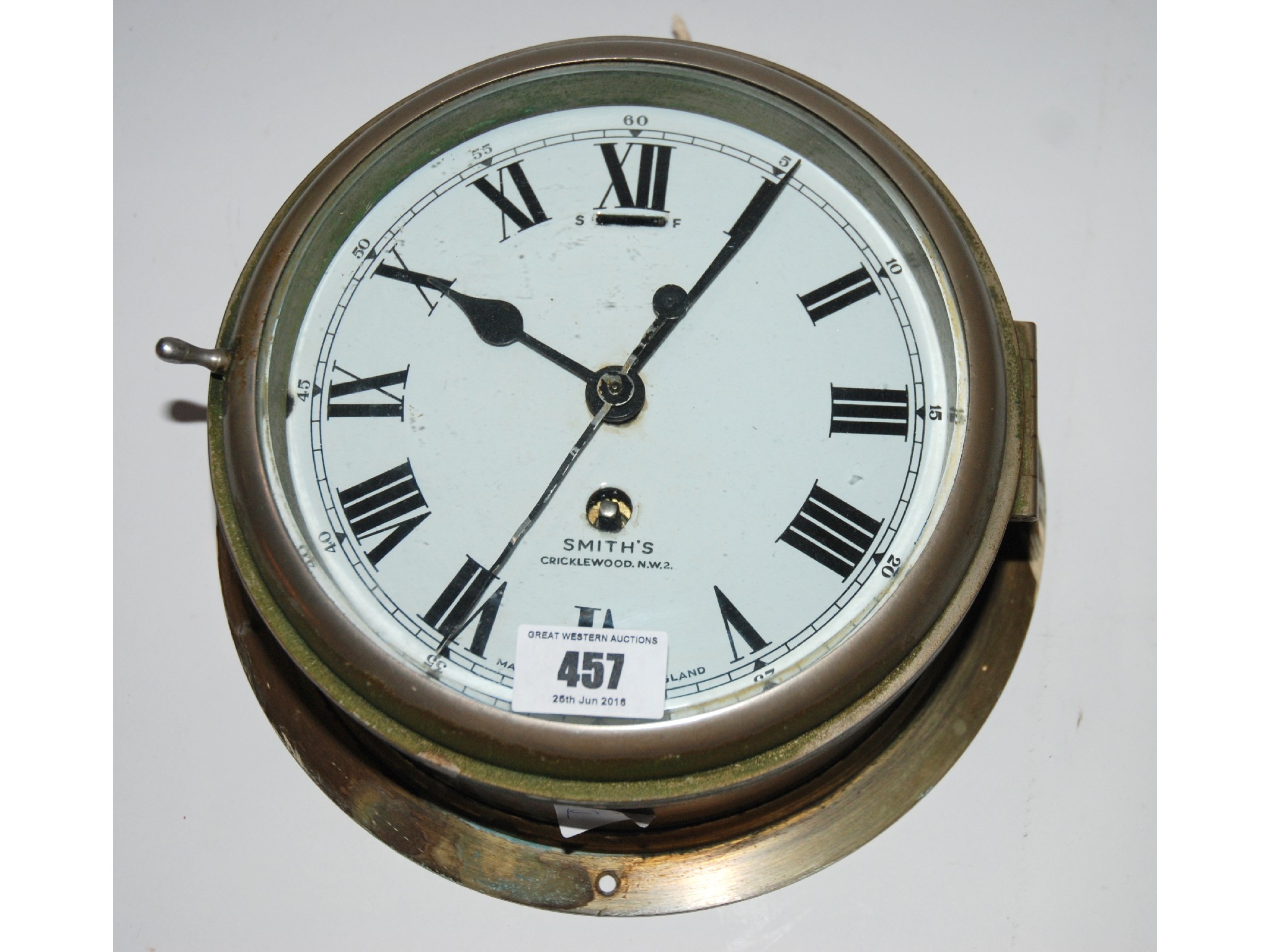 Appraisal: A brass Smith's bulk head clock with enamel dial