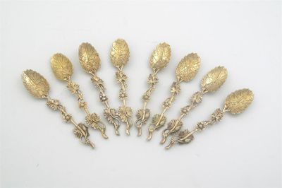 Appraisal: A set of eight silvergilt naturalistic teaspoons with leafy stems