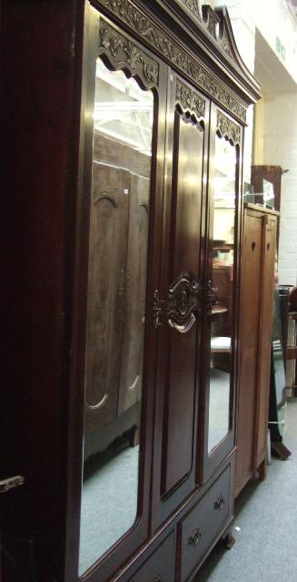 Appraisal: An Edwardian carved mahogany wardrobe the broken swan neck cornice