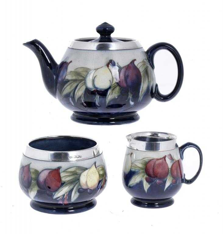 Appraisal: A MOORCROFT SILVER MOUNTED WISTERIA TEA SERVICE teapot and cover