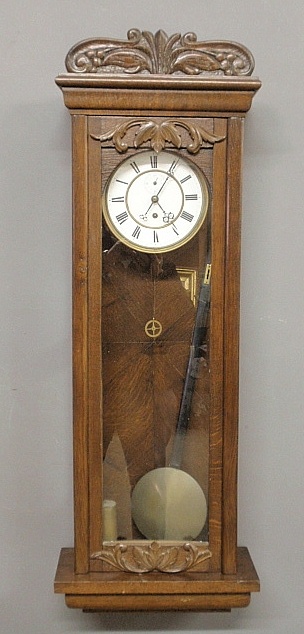 Appraisal: - German oak cased wall clock c with a porcelain