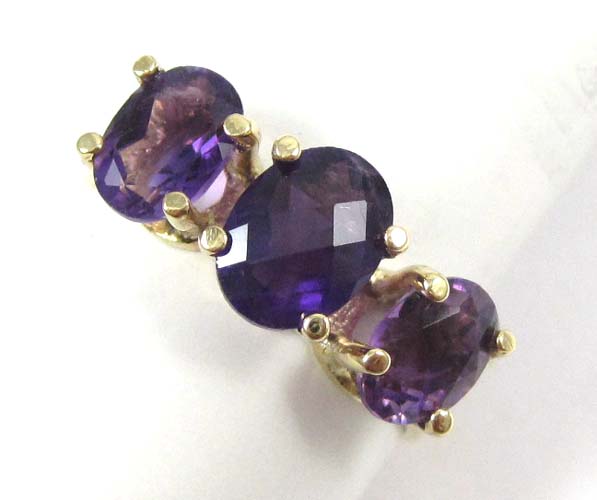 Appraisal: AMETHYST AND FOURTEEN KARAT GOLD RING with an oval checkerboard-cut