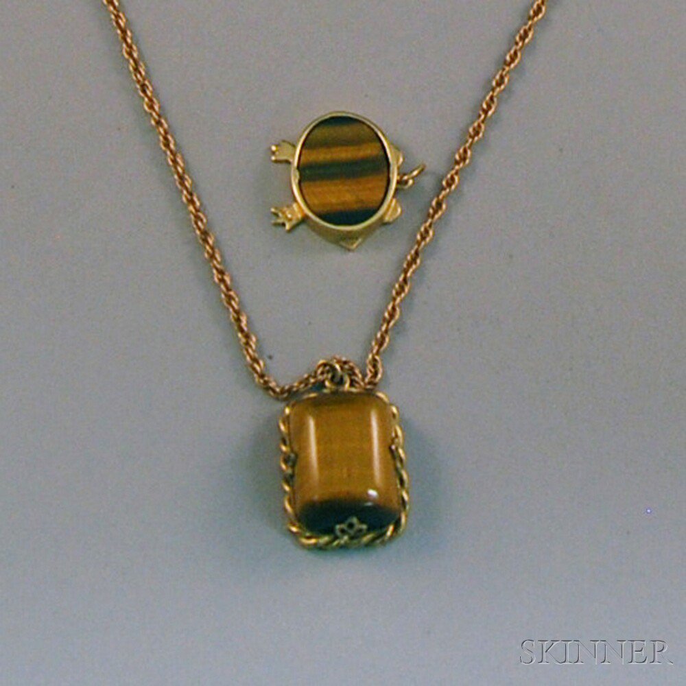 Appraisal: Two Cat's-Eye Pendants a rectangular pendant in gold-tone ropetwist frame