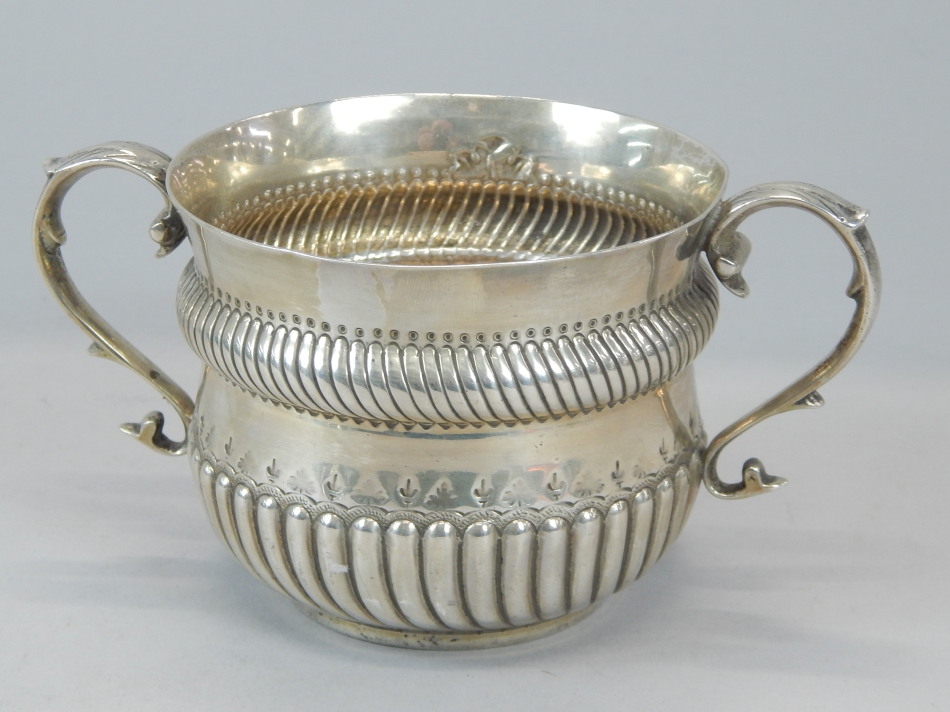 Appraisal: An Edwardian silver two handled sugar bowl or porringer the