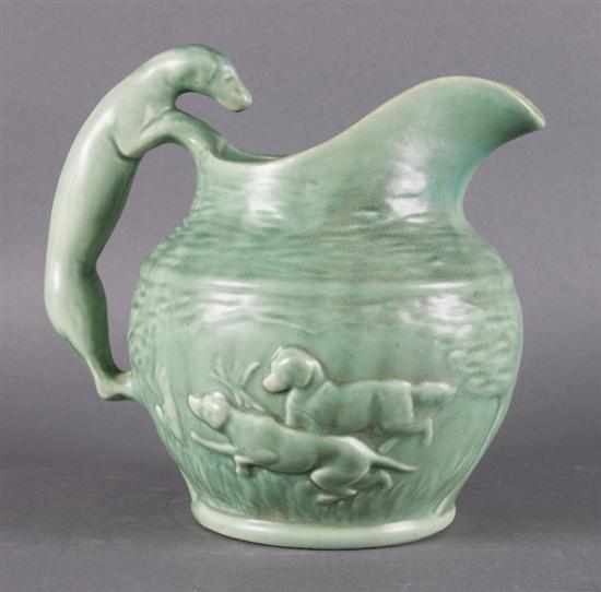 Appraisal: American green glazed pottery pitcher with dog relief decoration first