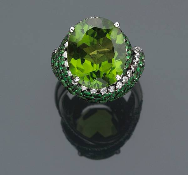 Appraisal: A peridot tsavorite garnet and diamond ring centering an oval-shaped