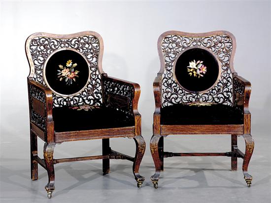 Appraisal: Pair Chinese carved oak and needlepoint chairs circa scrolling pierce-carved