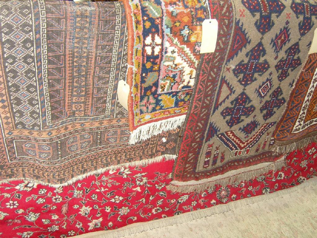 Appraisal: A collection of various eastern wool rugs including brown ground