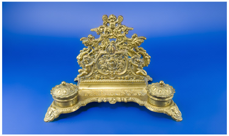 Appraisal: An Imposing Brass Double Inkstand with high relief design letter