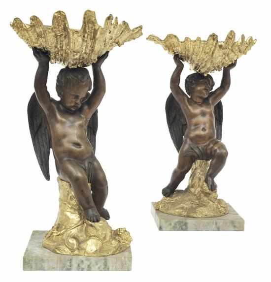 Appraisal: A PAIR OF FRENCH BRONZE AND GILT BRONZE PUTTI COMPORTS