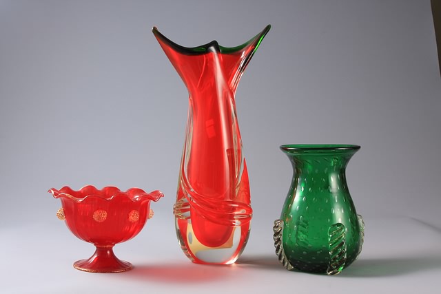 Appraisal: Three vases Green vases with controlled bottles and applied rope-twist