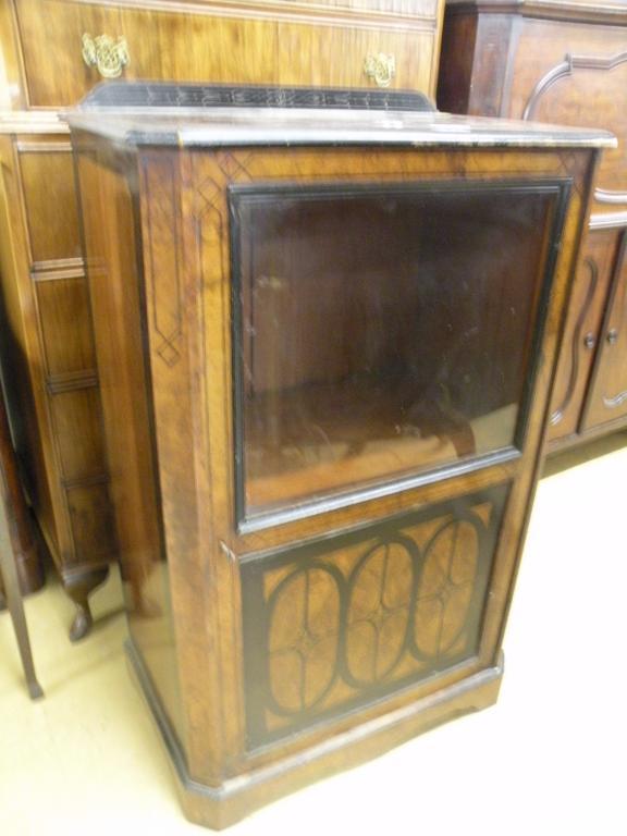 Appraisal: A Victorian walnut pier cabinet with a glazed door above