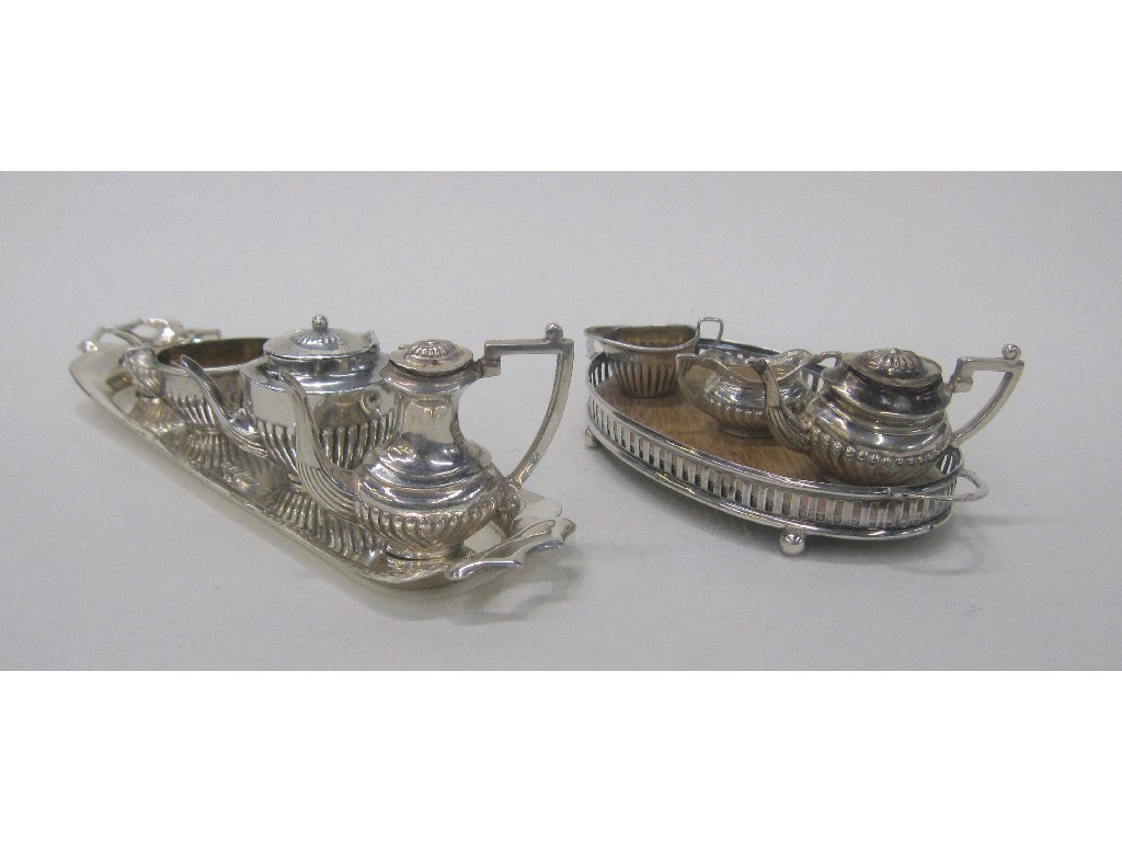 Appraisal: Lot comprising two miniature silver tea services a silver tray