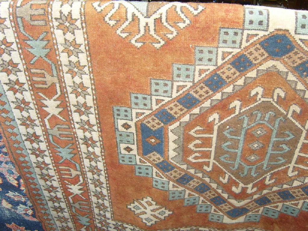 Appraisal: A terracotta colour ground eastern wool rug with hooked and