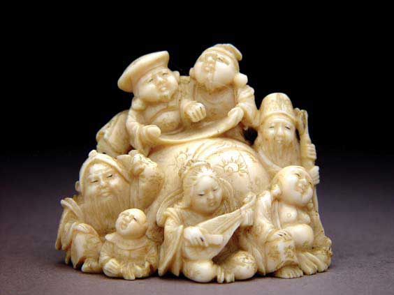 Appraisal: CARVED IVORY NETSUKE Finely carved ivory netsuke of the Seven