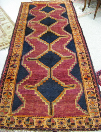 Appraisal: PERSIAN HALL RUG northwest tribal hand knotted in a plain